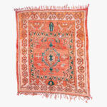 Handgeweven berber tapijt met terracotta, azuurblauwe en zeegroene patronen op een beige achtergrond, traditionele Marokkaanse ambacht.