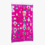 Opvallend fuchsia berber tapijt met een mozaïek van kleurrijke geometrische en traditionele patronen, handgemaakt en authentiek.